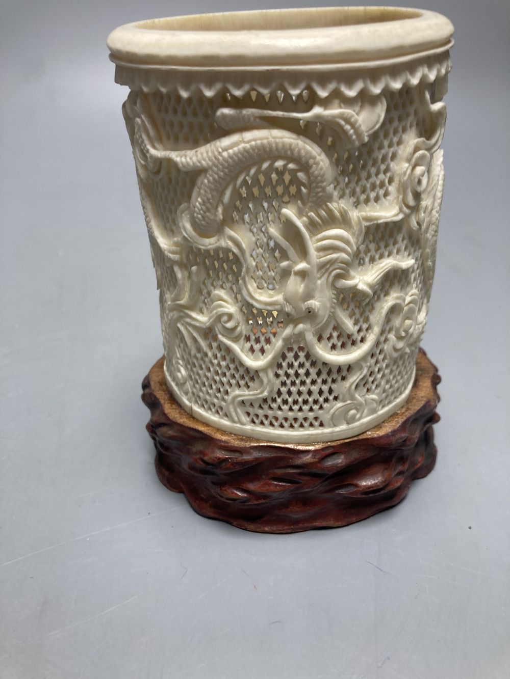 A Chinese cinnabar lacquer box, a carved ivory Chinese brush pot, 14cm and a cloisonne dish